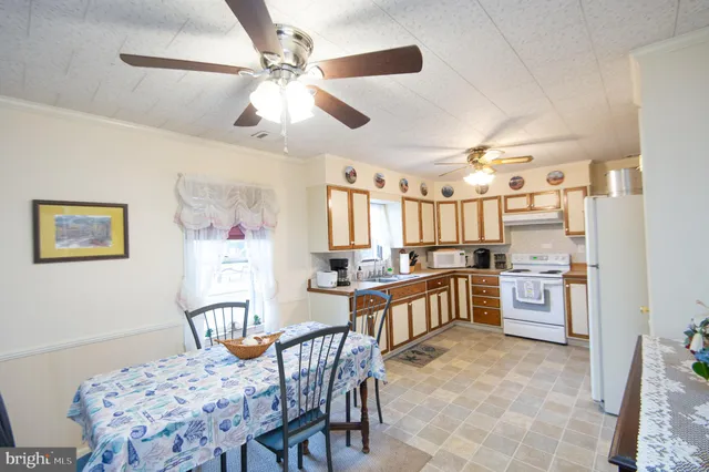 a kitchen with stainless steel appliances kitchen island granite countertop a sink and cabinets