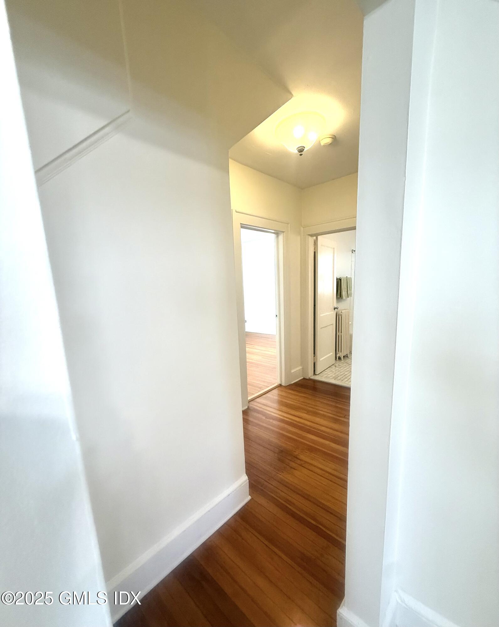 217 River Extension, Unit LOWER LEVEL Cos Cob, CT 06807 - Photo 11 of 16 a view of a hallway with wooden floor