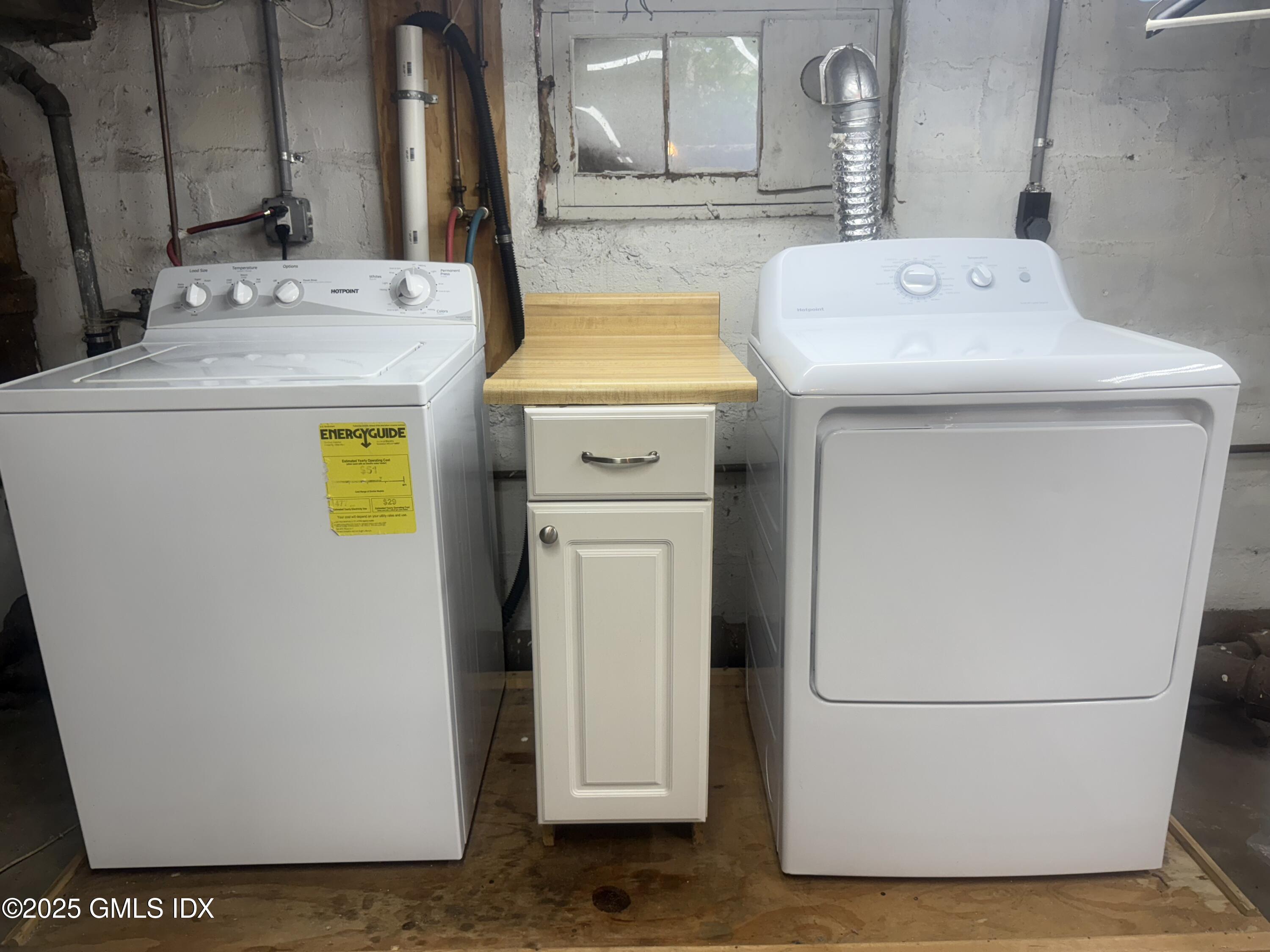 217 River Extension, Unit LOWER LEVEL Cos Cob, CT 06807 - Photo 16 of 16 a utility room with dryer and washer