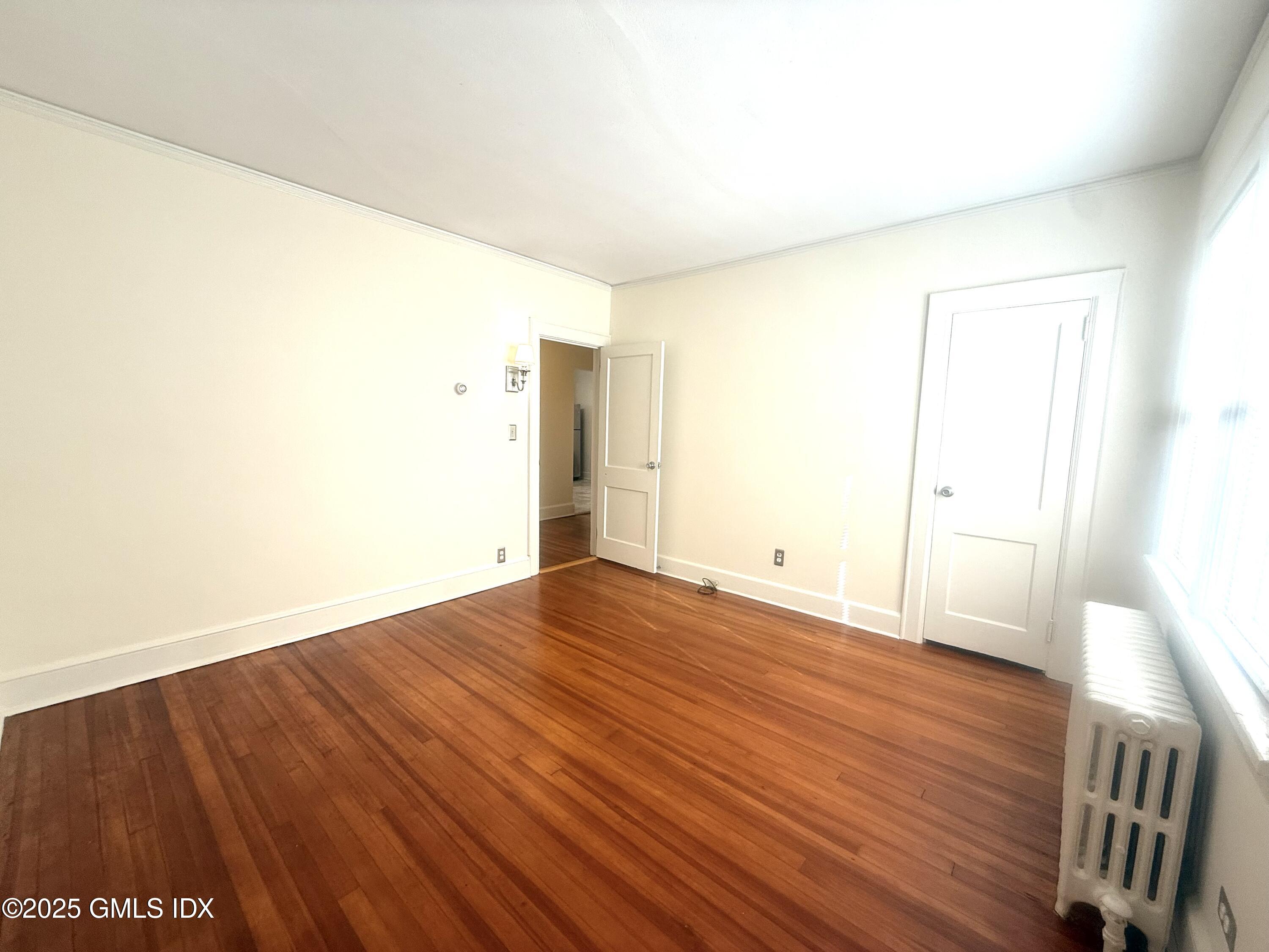 217 River Extension, Unit LOWER LEVEL Cos Cob, CT 06807 - Photo 8 of 16 a view of an empty room with wooden floor