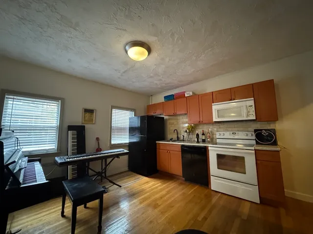 a kitchen with stainless steel appliances granite countertop a stove and a refrigerator