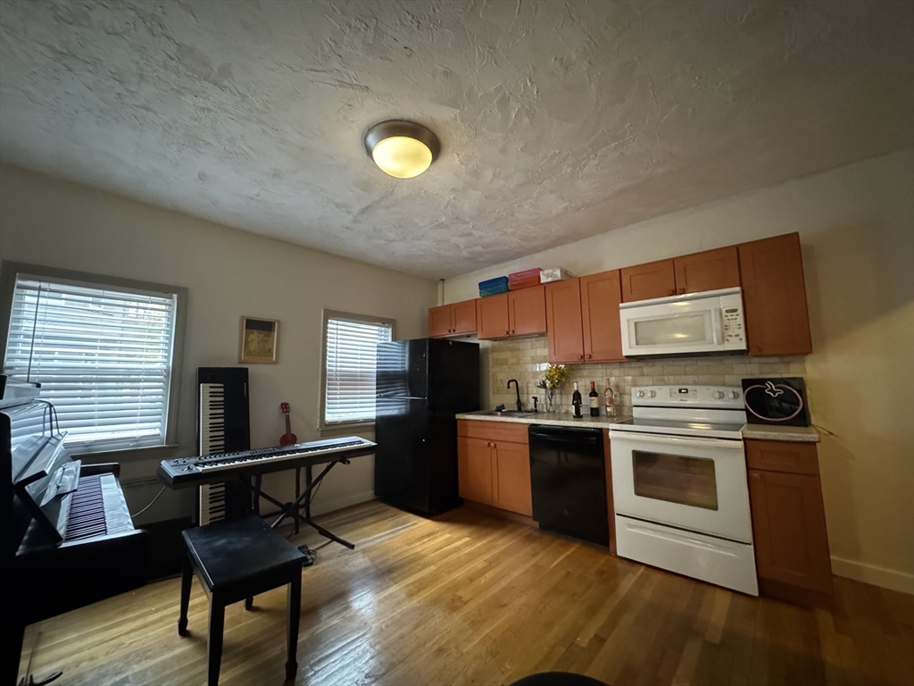 2 Alfred Street Boston, MA 02130 - Photo 5 of 11 a kitchen with stainless steel appliances granite countertop a stove and a refrigerator