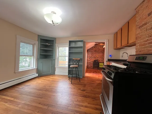 a living room with furniture fireplace and window