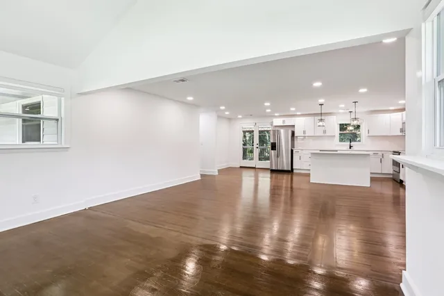 a kitchen with white cabinets and refrigerator
