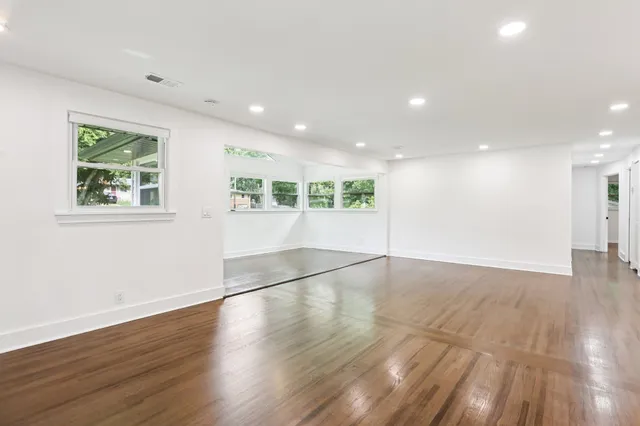 a kitchen with stainless steel appliances kitchen island a white cabinets and stove top oven
