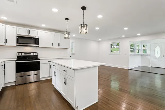 a view of an empty room with wooden floor