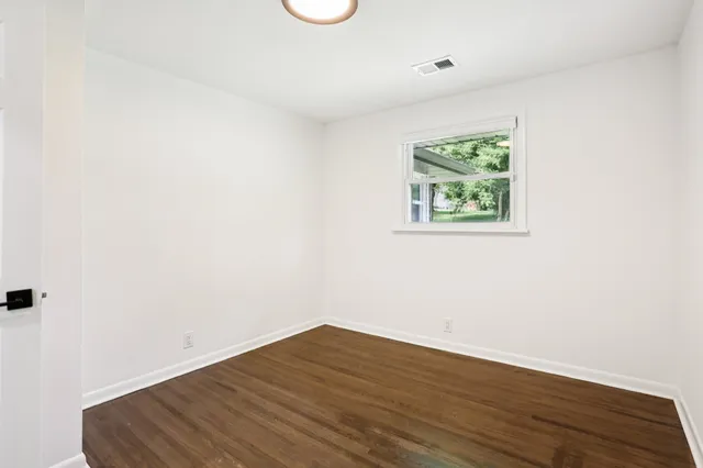 a view of an empty room and wooden floor