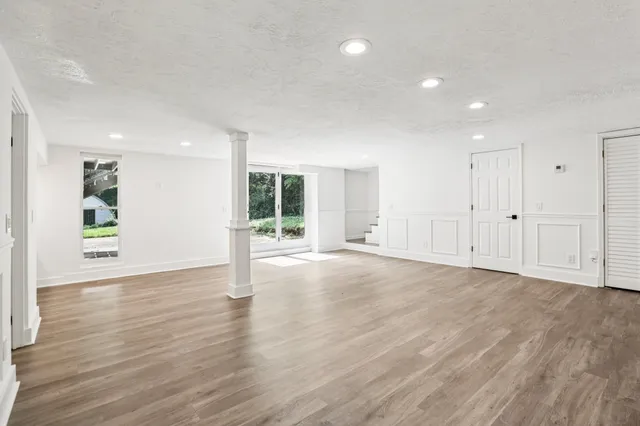 a view of a house with a big yard and large trees