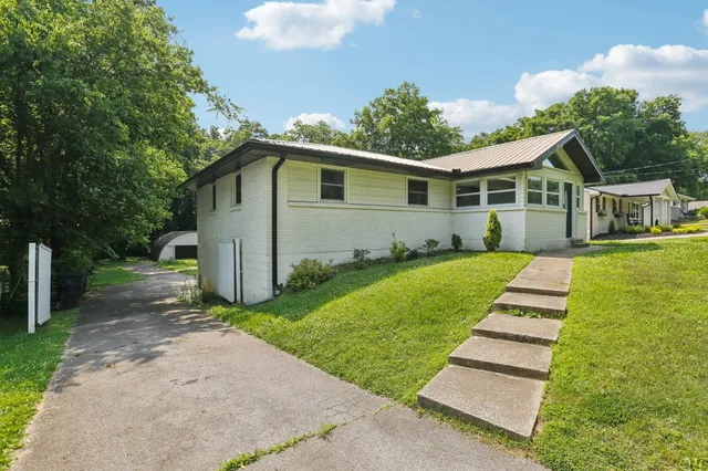 a view of a kitchen with a table and chairs in it