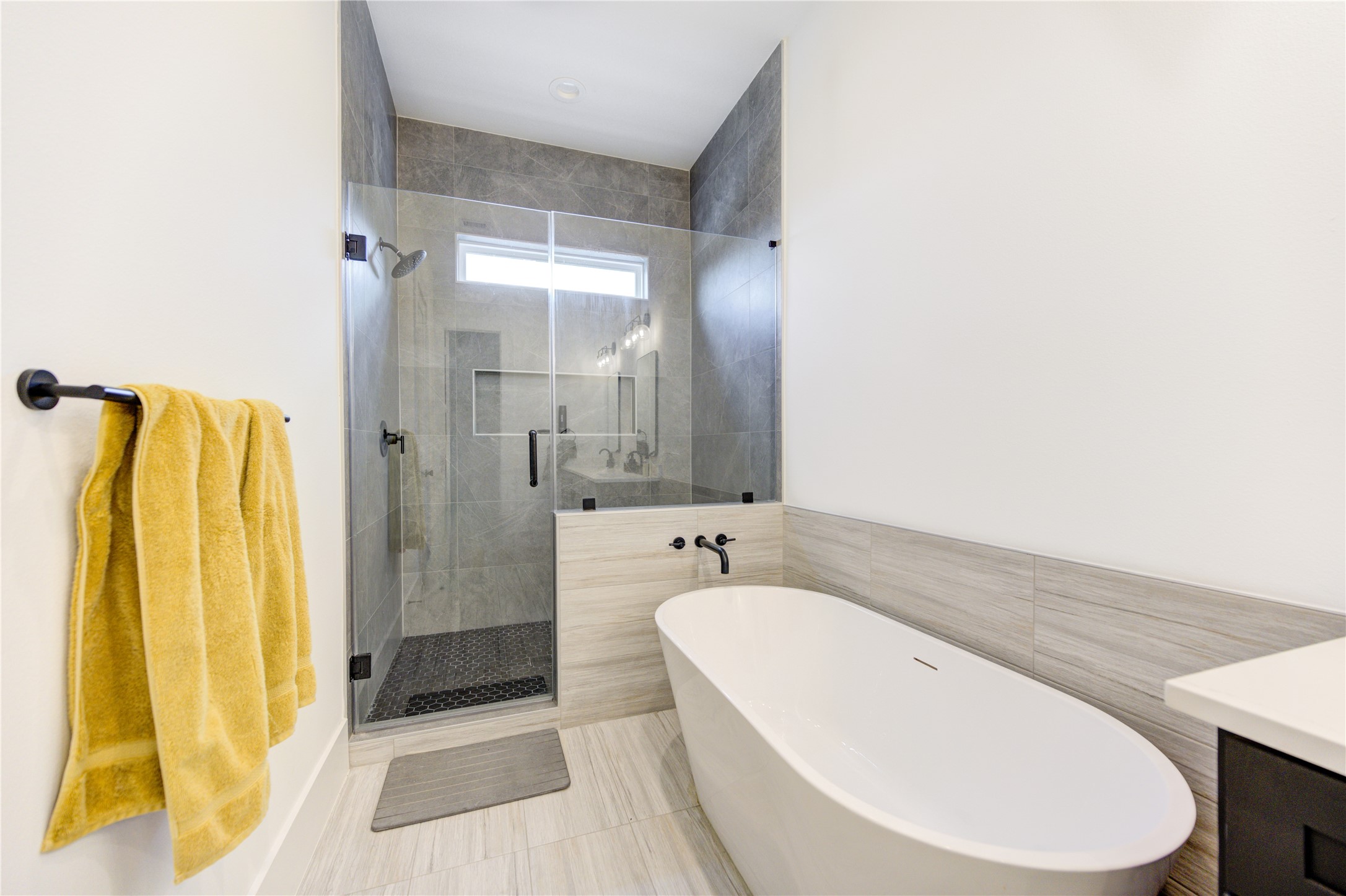 18 Sidney Street, Unit A Houston, TX 77003 - Photo 20 of 30 a spacious bathroom with a granite countertop sink and a mirror
