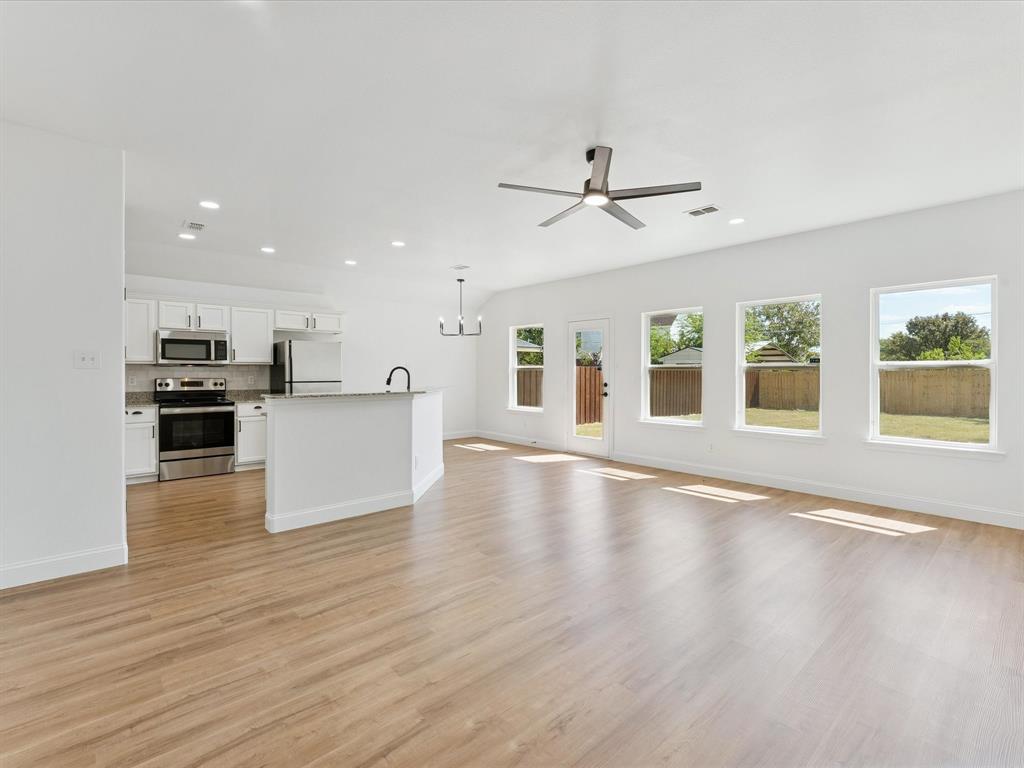 810 Ranch Road Dallas, TX 75253 - Photo 13 of 28 Unfurnished living room with a chandelier, light wood-style flooring, recessed lighting, and ceiling fan