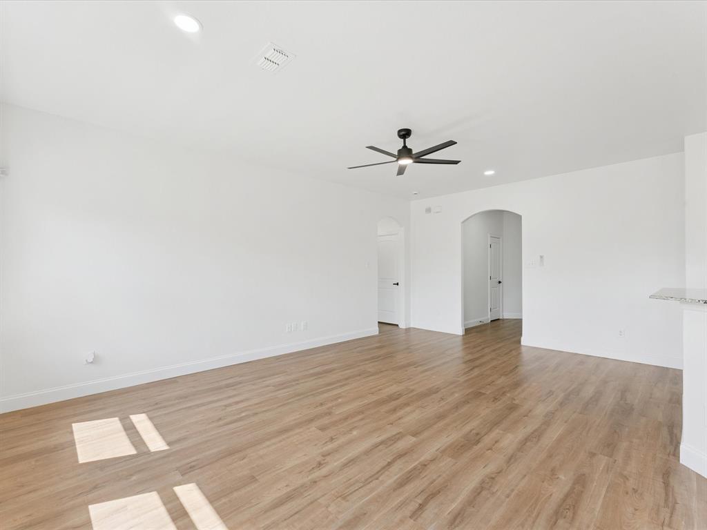 810 Ranch Road Dallas, TX 75253 - Photo 14 of 28 Unfurnished room featuring recessed lighting, arched walkways, light wood finished floors, and ceiling fan