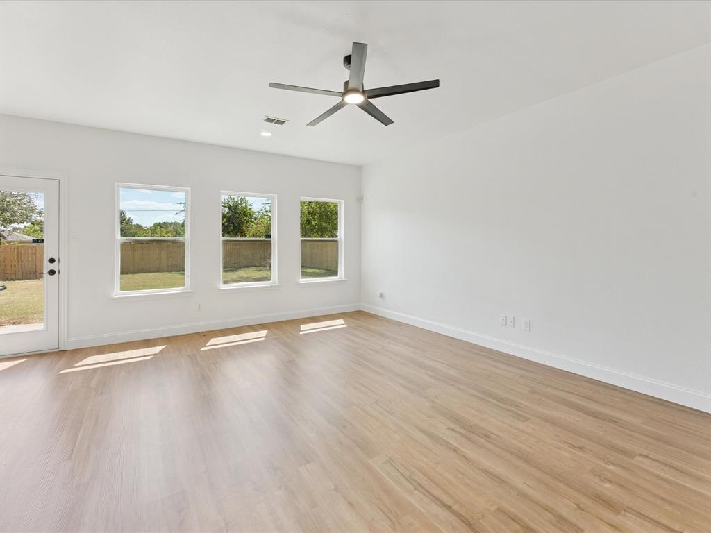 810 Ranch Road Dallas, TX 75253 - Photo 15 of 28 Spare room featuring light wood finished floors and a ceiling fan