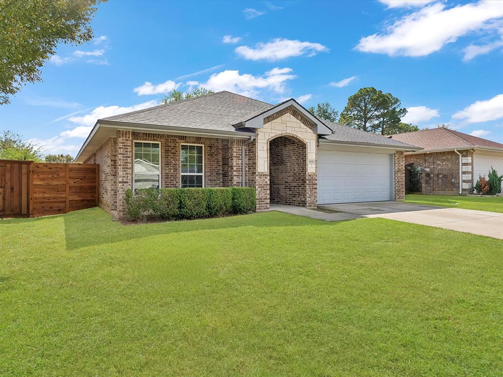 810 Ranch Road Dallas, TX 75253 - Photo 2 of 28 View of front of home with roof with shingles, brick siding, driveway, a garage, and stone siding