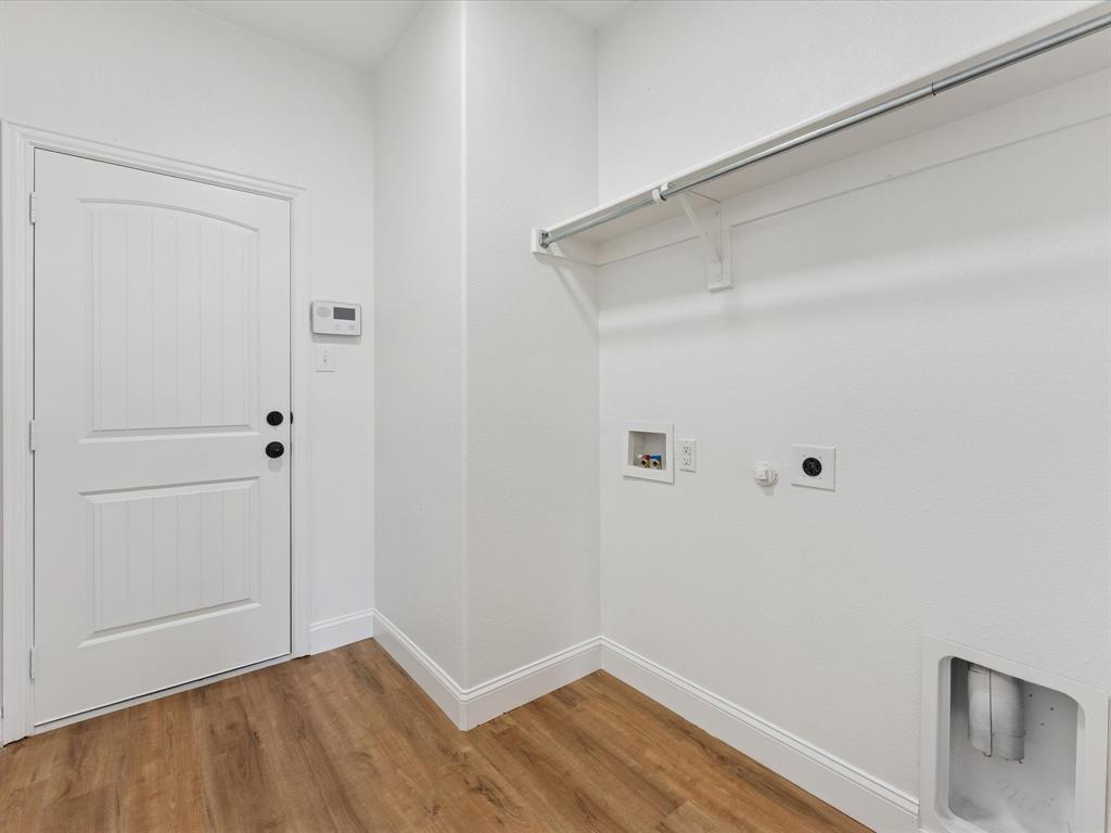 810 Ranch Road Dallas, TX 75253 - Photo 24 of 28 Laundry area with gas dryer hookup, wood finished floors, hookup for a washing machine, and hookup for an electric dryer