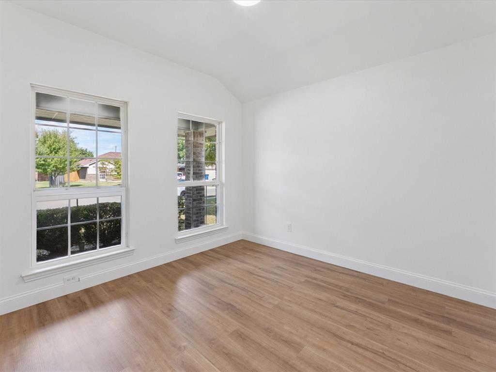 810 Ranch Road Dallas, TX 75253 - Photo 9 of 28 Empty room with vaulted ceiling and wood finished floors