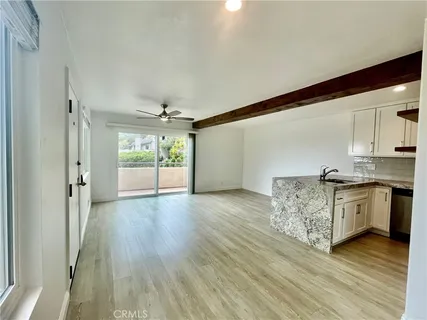a kitchen with granite countertop a stove top oven and cabinets