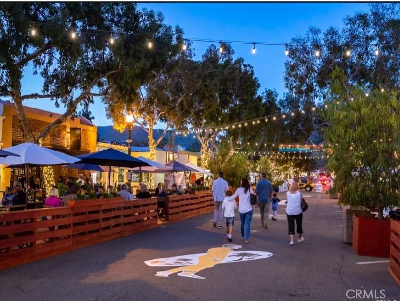 352 Y Place Laguna Beach, CA 92651 - Photo 20 of 22 a group of people sitting in a yard in front of retail shops