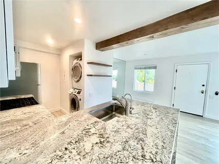 a bedroom with a bed and a large mirror on the dresser