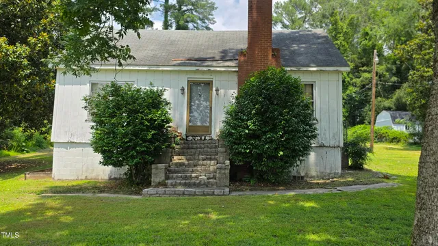 a front view of house with garden