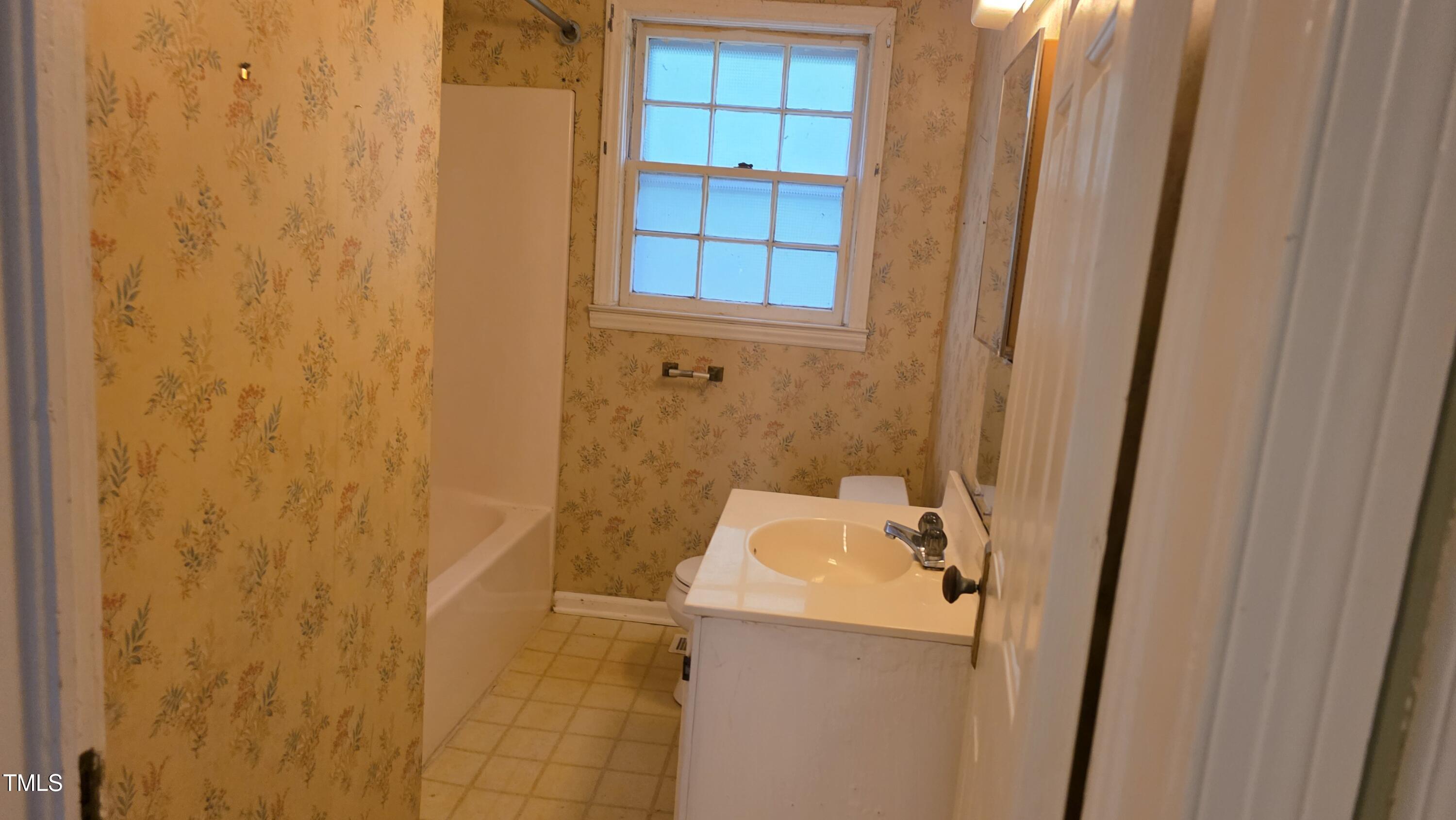 1015 Wait Avenue Wake Forest, NC 27587 - Photo 19 of 19 a bathroom with a sink and mirror
