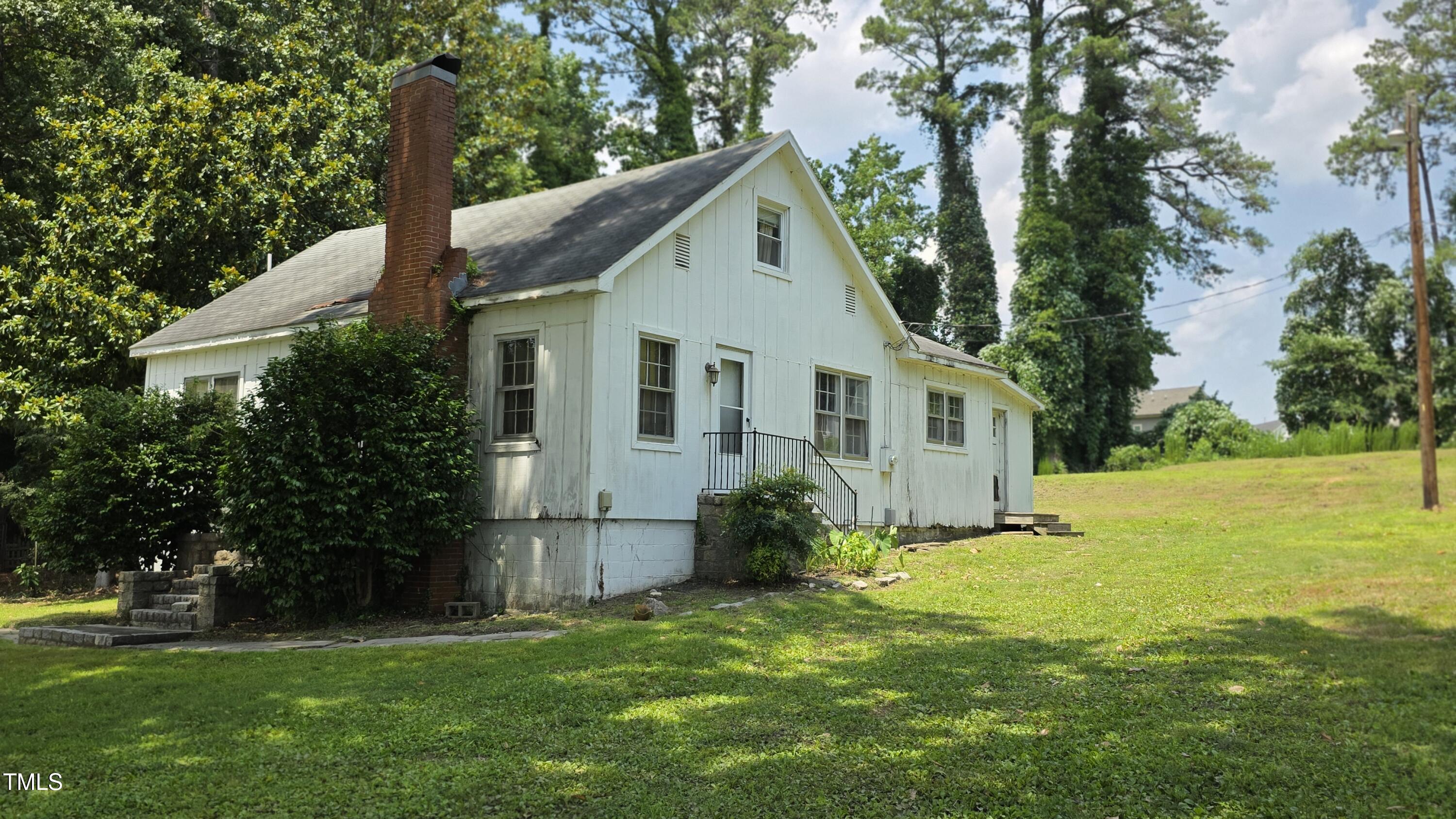 1015 Wait Avenue Wake Forest, NC 27587 - Photo 7 of 19 a view of a yard in front of a house with plants and large tree