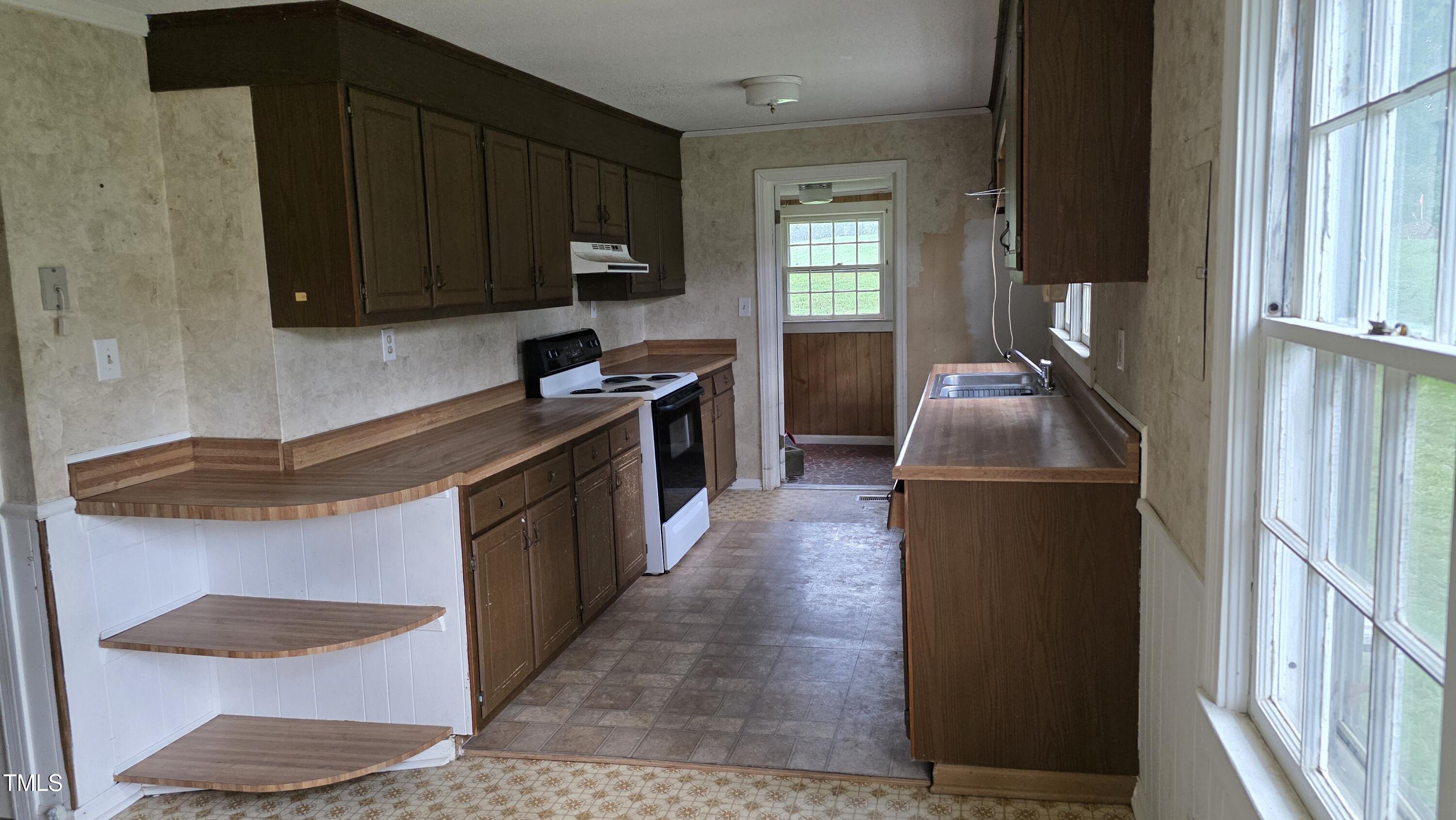 1015 Wait Avenue Wake Forest, NC 27587 - Photo 9 of 19 a kitchen with stainless steel appliances granite countertop a stove a sink and a refrigerator