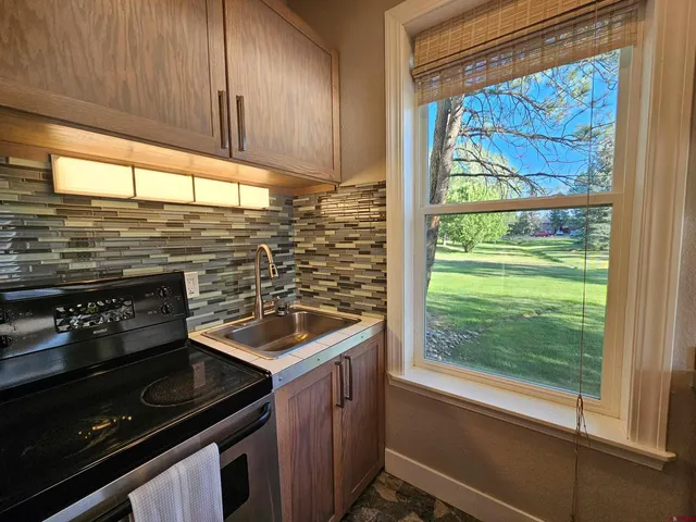 a kitchen with a stove a sink and a cabinets