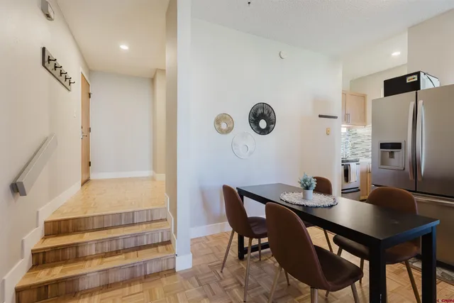 a view of dining room and kitchen with a table chairs and a refrigerator