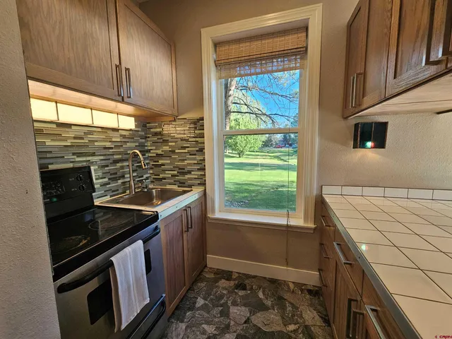 a kitchen that has a sink and a stove