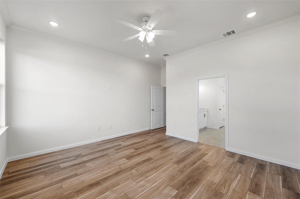 912 Gallant Fox Hewitt, TX 76643 - Photo 10 of 31 an empty room with wooden floor and a ceiling fan