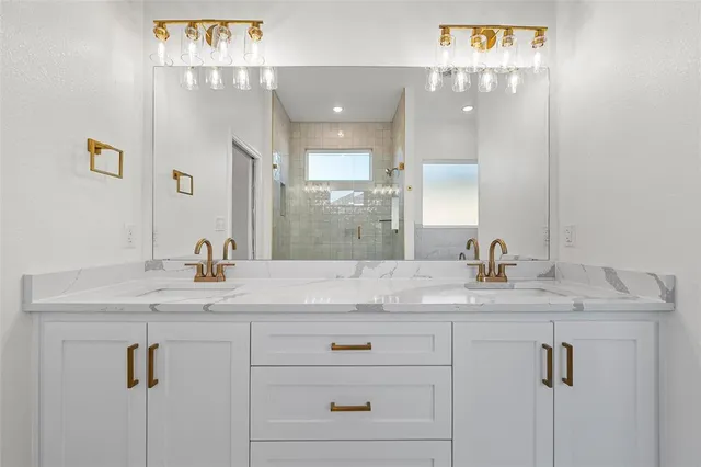 an empty room with wooden floor chandelier fan and windows
