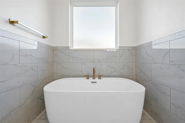an empty room with wooden floor and a ceiling fan