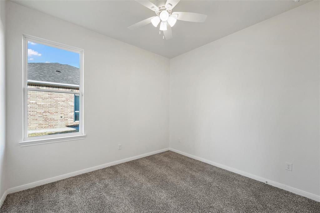 912 Gallant Fox Hewitt, TX 76643 - Photo 14 of 31 an empty room with a window and a chandelier fan