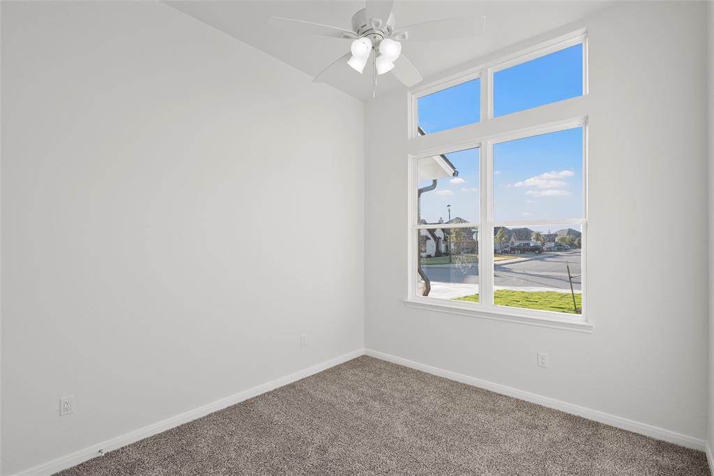 912 Gallant Fox Hewitt, TX 76643 - Photo 20 of 31 an empty room with chandelier fan and windows