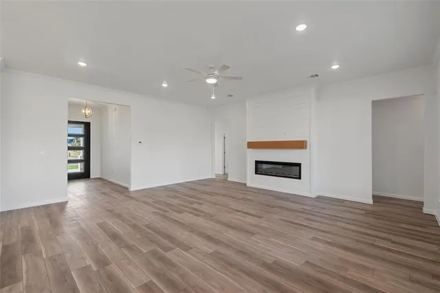 a kitchen with kitchen island granite countertop a sink a counter space and wooden floor