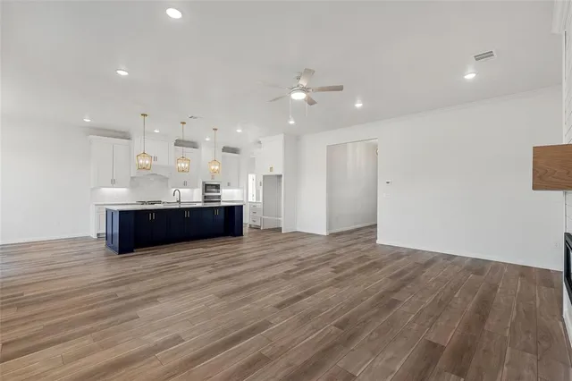a view of empty room with furniture and wooden floor