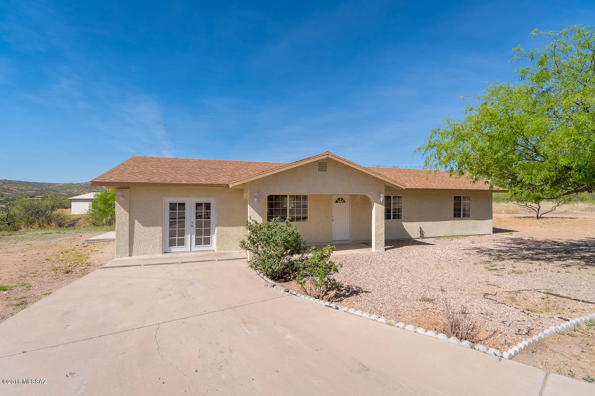 549 Valdez Court Rio Rico, AZ 85648 - Photo 3 of 27 a front view of a house with a yard and garage