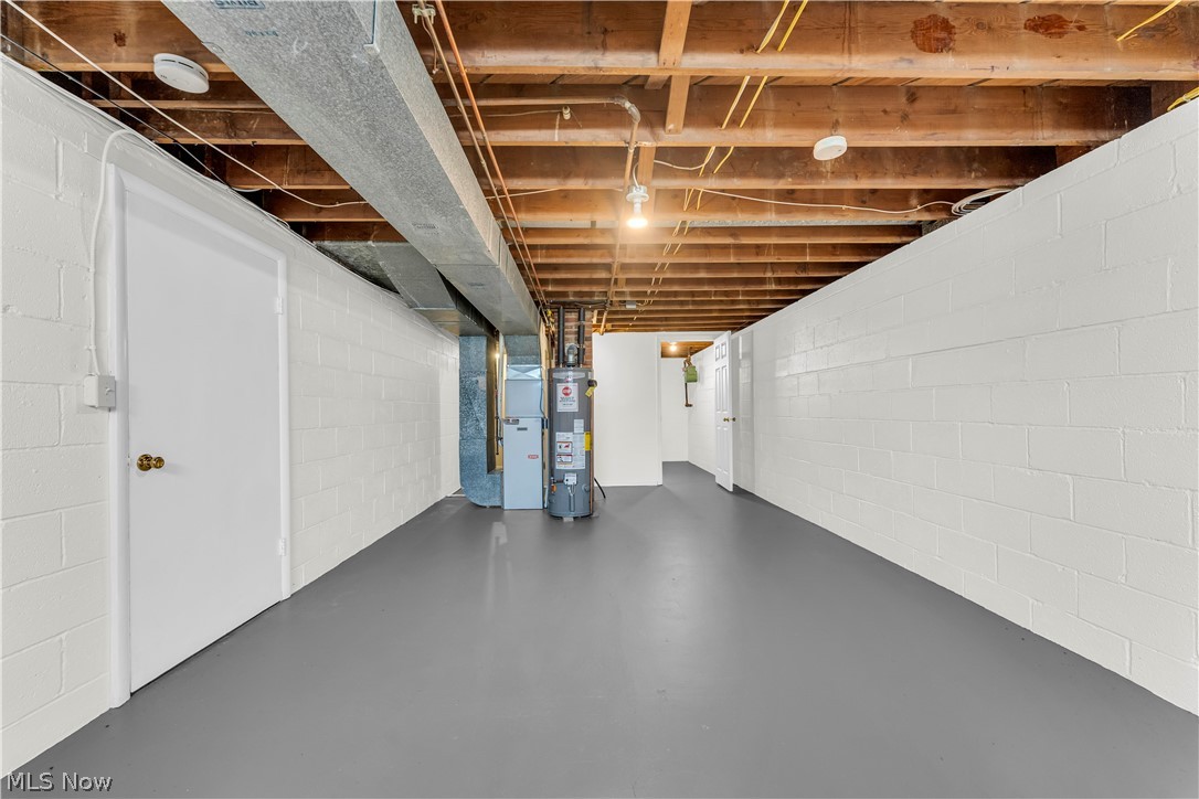 9716 Alexander Road Cleveland, OH 44125 - Photo 20 of 30 Unfinished basement featuring heating unit and water heater