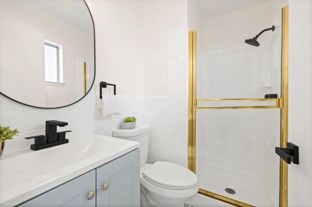 a bathroom with a sink a toilet and a mirror