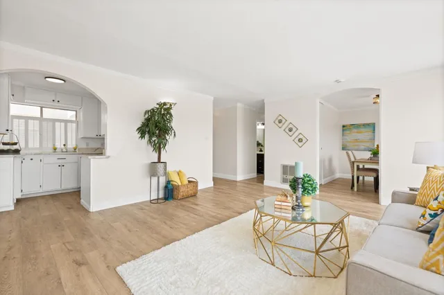 a living room with furniture and kitchen view