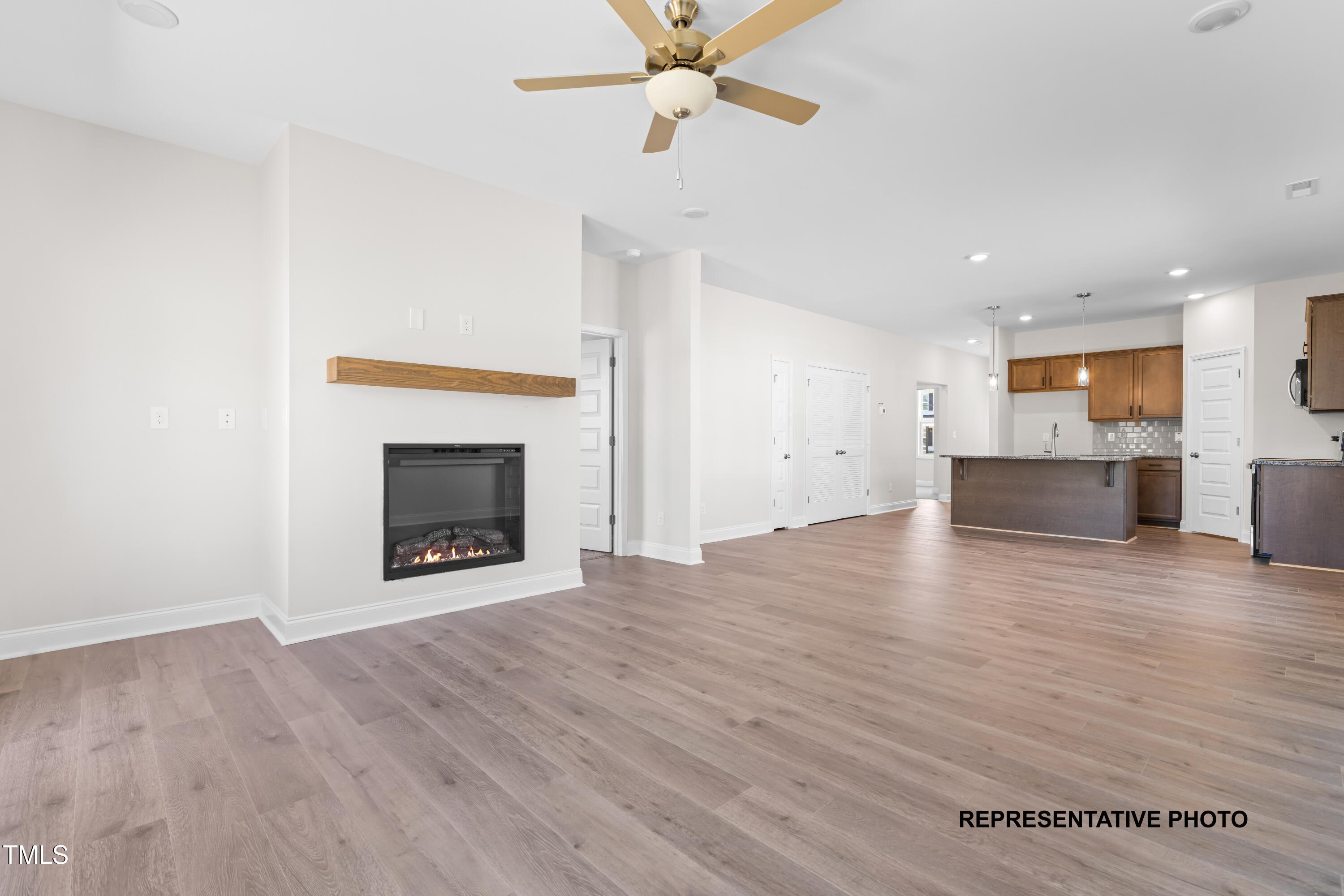 378 Bluejay Street Clayton, NC 27520 - Photo 6 of 13 a view of empty room with wooden floor and fireplace