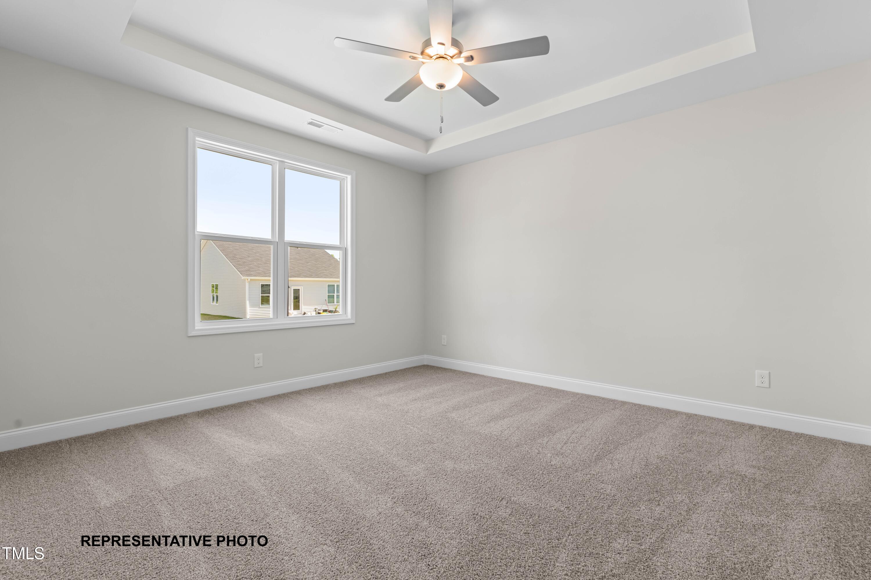 378 Bluejay Street Clayton, NC 27520 - Photo 7 of 13 an empty room with windows and ceiling fan