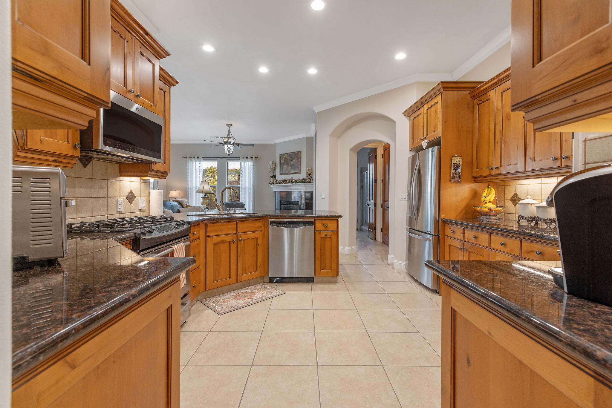729 St Thomas Court Exeter, CA 93221 - Photo 22 of 66 a large kitchen with stainless steel appliances granite countertop a sink and a stove