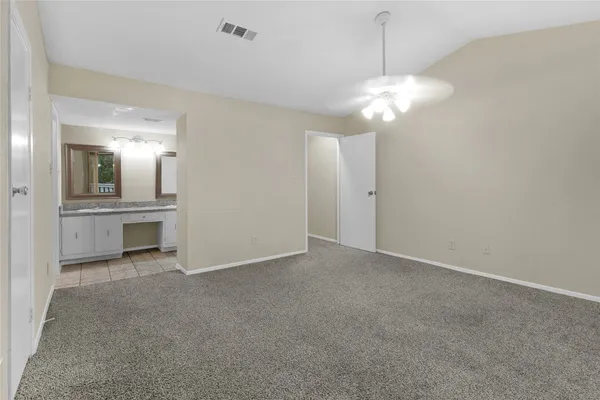 an empty room with a kitchen and a sink