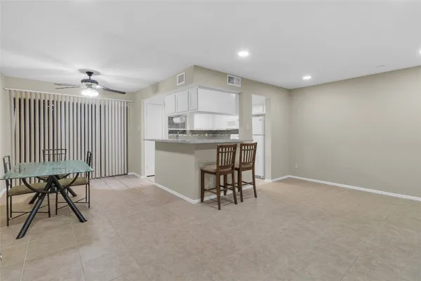 a kitchen with a table and chairs in it