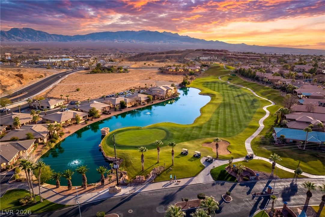 1460 Blue Ridge Trail Mesquite, NV 89027 - Photo 39 of 39 Golden hour illuminates this desert oasis, featuring a verdant golf course winding around a tranquil lake and residential properties.