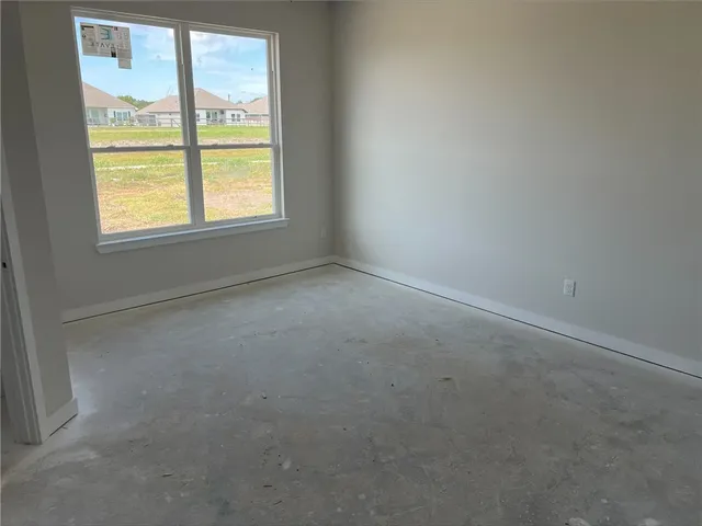 a bathroom with a granite countertop sink and a window