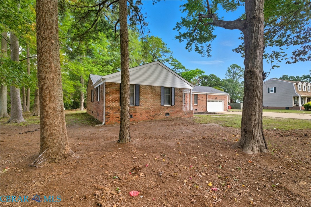 718 Dandy Loop Road Yorktown, VA 23692 - Photo 38 of 42 View of front facade featuring crawl space, brick siding, a garage, and driveway