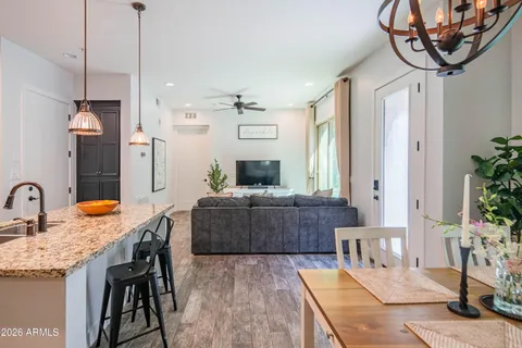 a large kitchen with a table and chairs